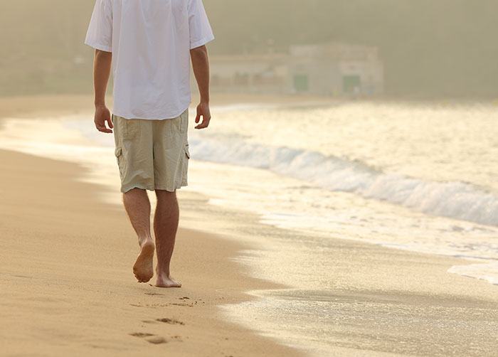 guy walking on the beach in Miami Florida