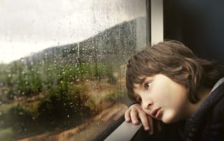 boy staring out window
