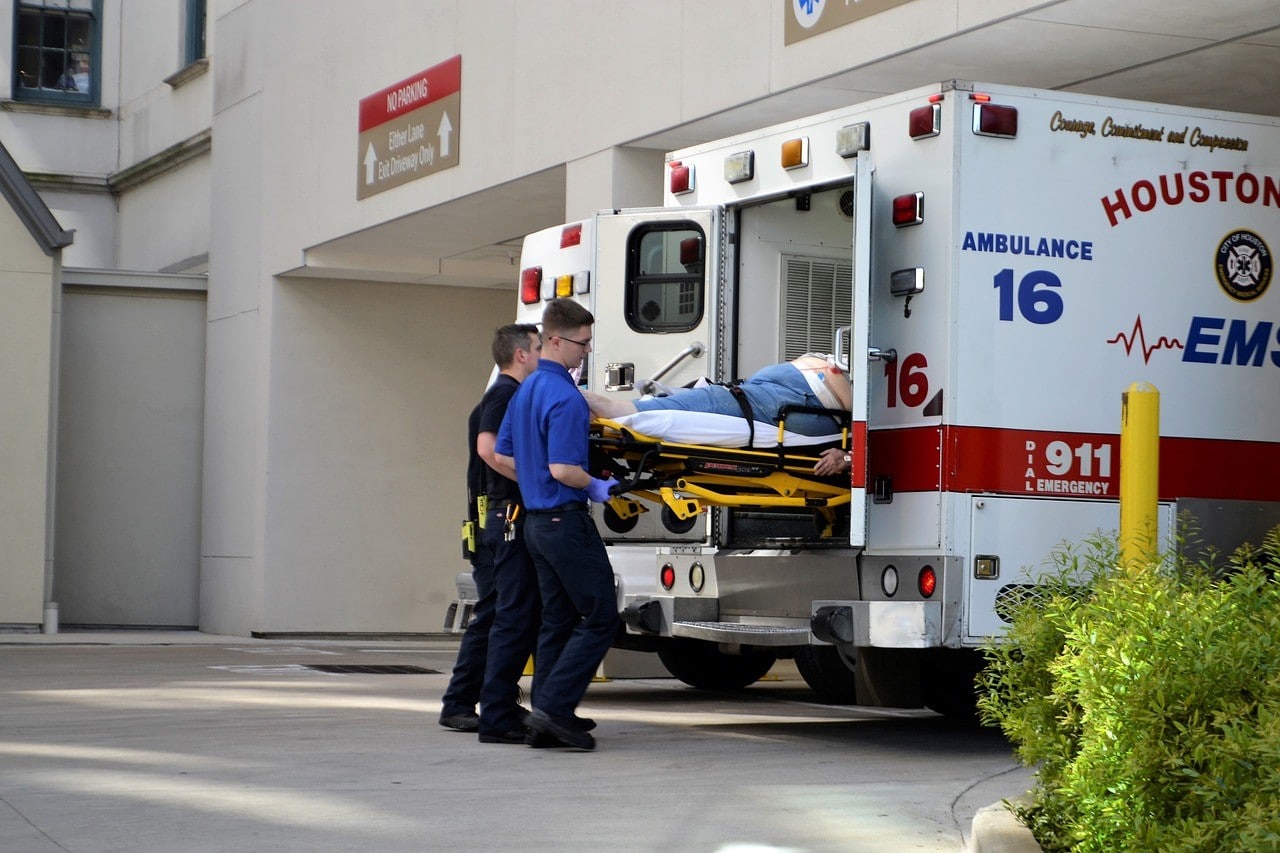 person being loaded into ambulance by EMT